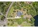 High angle aerial view shows home with lake and lots of trees at 1303 Sultan Cir, Chuluota, FL 32766