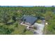 Stunning aerial view of a single-story home surrounded by lush greenery and a paved driveway at 1303 Sultan Cir, Chuluota, FL 32766