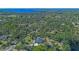 Expansive aerial view of the property showcasing the home's location amidst lush greenery and a serene lake at 1303 Sultan Cir, Chuluota, FL 32766