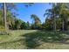 Lush backyard featuring mature trees and green grass at 1303 Sultan Cir, Chuluota, FL 32766