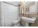 Cozy bathroom with a pedestal sink, tiled floors, and a shower with a curtain at 1303 Sultan Cir, Chuluota, FL 32766