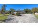 Spacious driveway leading to a well-kept home with a two car garage and landscaped yard at 1303 Sultan Cir, Chuluota, FL 32766