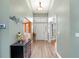 Welcoming entryway with hardwood floors and an elegant chandelier at 1303 Sultan Cir, Chuluota, FL 32766