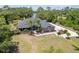 Expansive home with two palm trees, a winding walkway, and a beautifully landscaped garden bed at 1303 Sultan Cir, Chuluota, FL 32766