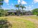 Brick home with a manicured lawn, walkway, garden beds, and well-maintained landscaping at 1303 Sultan Cir, Chuluota, FL 32766