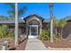 Inviting front porch adorned with lush greenery and a charming brick walkway creates a warm and welcoming entrance to the home at 1303 Sultan Cir, Chuluota, FL 32766