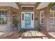 Cozy front porch with brick accents, decorative plants, and a welcoming door mat at 1303 Sultan Cir, Chuluota, FL 32766