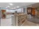 Bright kitchen featuring white cabinetry, modern appliances, and a functional center island with wine rack at 1303 Sultan Cir, Chuluota, FL 32766