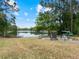 Picturesque lakeside yard with seating area and beautiful waterfront views at 1303 Sultan Cir, Chuluota, FL 32766