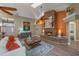 Cozy living room showcasing a brick fireplace, skylight, and neutral color scheme at 1303 Sultan Cir, Chuluota, FL 32766