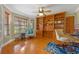 Comfortable living room featuring built-in bookshelves, hardwood floors, and natural light at 1303 Sultan Cir, Chuluota, FL 32766