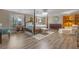 Elegant main bedroom with four-poster bed, stylish chandelier, sitting area and plenty of natural light at 1303 Sultan Cir, Chuluota, FL 32766
