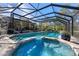 Beautiful screened-in pool area with a spa, connected to a spacious patio, and lush landscaping at 1303 Sultan Cir, Chuluota, FL 32766