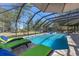 Inviting screened-in pool area with comfortable lounge chairs and lush green surroundings for relaxation at 1303 Sultan Cir, Chuluota, FL 32766