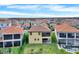 Aerial view of a home with a well-manicured lawn, screened-in patio, and tiled roof at 13169 Bromborough Dr, Orlando, FL 32832