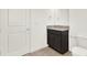 Powder room with single vanity and dark wood cabinets at 13169 Bromborough Dr, Orlando, FL 32832