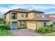 Stunning two-story home with a tile roof, stone accents, a small balcony, and manicured landscaping at 13169 Bromborough Dr, Orlando, FL 32832