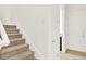 Carpeted staircase with white walls leads to the upper level of the home at 13169 Bromborough Dr, Orlando, FL 32832