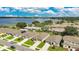 Scenic aerial view showcasing a lakeside community featuring neatly arranged homes, green spaces, and a tranquil blue lake nearby at 132 Lake Smart Cir, Winter Haven, FL 33881