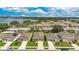 Picturesque aerial view of a lakeside community featuring well-maintained homes, green spaces, and a serene blue lake backdrop at 132 Lake Smart Cir, Winter Haven, FL 33881