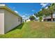 Backyard features lush green grass and a partial view of adjacent houses at 132 Lake Smart Cir, Winter Haven, FL 33881