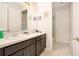 Bathroom features dual sinks with a white countertop and modern lighting at 132 Lake Smart Cir, Winter Haven, FL 33881