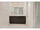 Bathroom featuring double vanity with dark cabinetry, a large mirror, and tiled floors at 132 Lake Smart Cir, Winter Haven, FL 33881