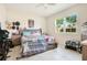 Bright bedroom features tiled floors, a ceiling fan, and a large window with backyard views at 132 Lake Smart Cir, Winter Haven, FL 33881