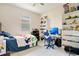 Bedroom featuring bright natural light, a bed with blue bedding and wall shelves at 132 Lake Smart Cir, Winter Haven, FL 33881