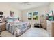 Well-lit bedroom with a ceiling fan, tiled floors, and ample natural light at 132 Lake Smart Cir, Winter Haven, FL 33881