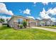 Charming single Gathering home featuring stone accents, neutral paint, manicured lawn and a two car garage at 132 Lake Smart Cir, Winter Haven, FL 33881