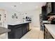 Kitchen features dark wood cabinetry, an island, stainless steel appliances and white countertops at 132 Lake Smart Cir, Winter Haven, FL 33881