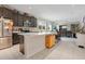 Open concept kitchen featuring dark wood cabinetry, stainless steel appliances, and an eat-in dining space at 132 Lake Smart Cir, Winter Haven, FL 33881