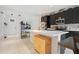 Open concept kitchen featuring dark wood cabinetry, stainless steel appliances, and a breakfast bar at 132 Lake Smart Cir, Winter Haven, FL 33881