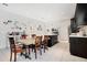 Open concept kitchen featuring dark wood cabinetry, an island, stainless steel appliances, and an eat-in dining space at 132 Lake Smart Cir, Winter Haven, FL 33881