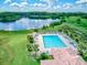 Aerial view of a community pool with lake and lush landscaping, perfect for relaxation and recreation at 13209 Wild Duck Ct, Orlando, FL 32828