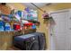 Functional laundry room with washer, dryer, and shelving for storage at 13209 Wild Duck Ct, Orlando, FL 32828