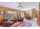 Cozy living room with tile floors and lots of natural light from large windows at 13209 Wild Duck Ct, Orlando, FL 32828