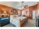 Large main bedroom with ceiling fan and an en-suite bathroom at 13209 Wild Duck Ct, Orlando, FL 32828