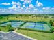 Aerial view of tennis courts near lush lawns, offering residents an active and engaging lifestyle at 13209 Wild Duck Ct, Orlando, FL 32828