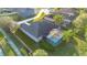 Aerial view of the home, highlighting the screened-in pool, spacious backyard, and proximity to lush surroundings at 13330 Meergate Cir, Orlando, FL 32837