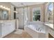 Bright bathroom with a separate glass shower and soaking tub at 13330 Meergate Cir, Orlando, FL 32837