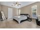 Bright bedroom featuring a modern black bed frame, sleek nightstand, and light wood floors at 13330 Meergate Cir, Orlando, FL 32837