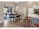 Bright dining area features a table with benches and stools, modern lighting, and a sliding glass door at 13330 Meergate Cir, Orlando, FL 32837