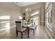 Bright dining room featuring modern table set, neutral walls, wood-style tile floor, and large window at 13330 Meergate Cir, Orlando, FL 32837