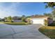 Wide driveway leading to a spacious two-car garage, framed by a well-maintained lawn and mature trees at 13330 Meergate Cir, Orlando, FL 32837