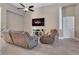 Comfortable living room featuring a media center, reclining sofa, ceiling fan, and neutral color palette at 13330 Meergate Cir, Orlando, FL 32837