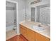 Bathroom with double vanity sink, a large mirror, and a tub/shower at 13941 Fairway Island Dr # 733, Orlando, FL 32837