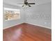 Bedroom features hardwood floors, a ceiling fan, and a window at 13941 Fairway Island Dr # 733, Orlando, FL 32837