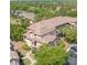 Aerial view of the condominium complex featuring a terracotta roof and ample parking at 13941 Fairway Island Dr # 733, Orlando, FL 32837